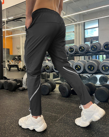 Pantalón deportivo impermeable de rayas de alto rendimiento y corte ajustado